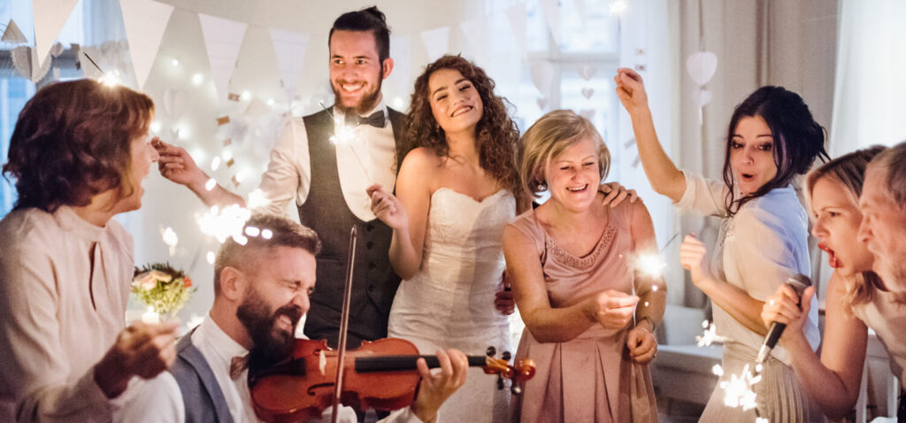 A group of people celebrating indoors with sparklers during a festive occasion.